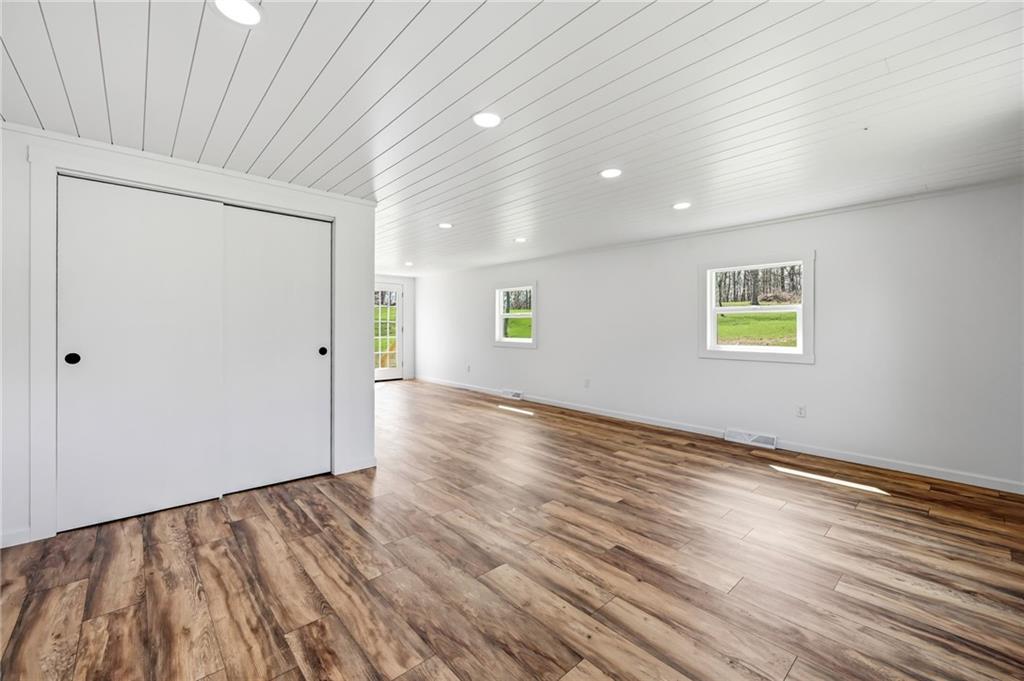 311 Oakdale Road Darlington, PA 16115 - Photo 14 of 32 an empty room with wooden floor and windows