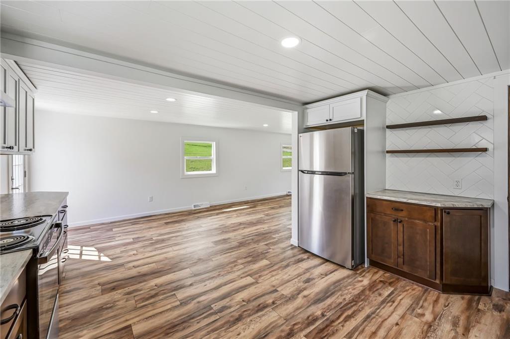 311 Oakdale Road Darlington, PA 16115 - Photo 19 of 32 a view of a refrigerator in kitchen and wooden floor