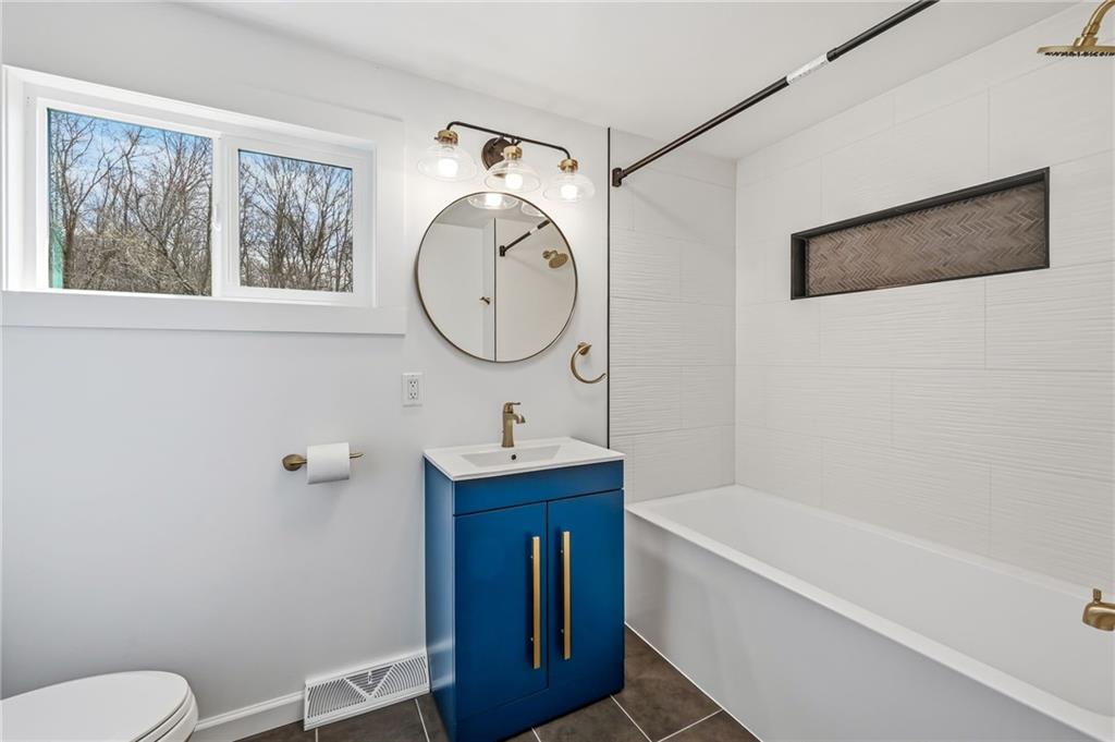 311 Oakdale Road Darlington, PA 16115 - Photo 24 of 32 a bathroom with a toilet sink and mirror