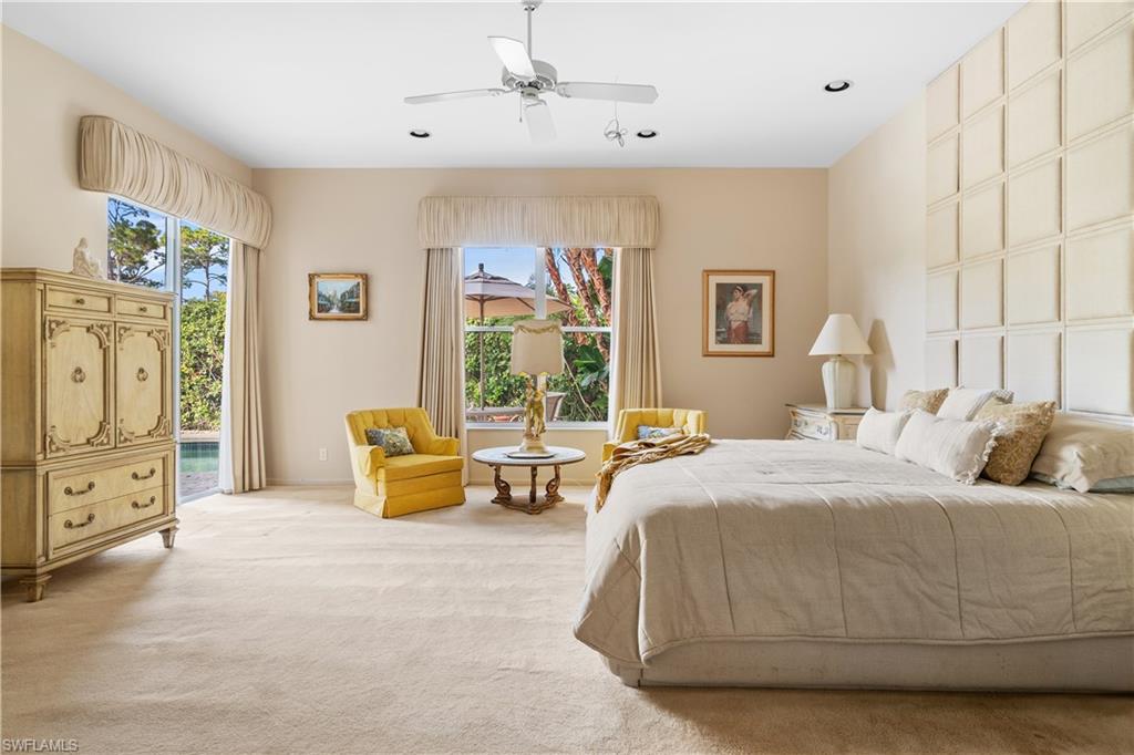2399 Northwest 24th Street Boca Raton, FL 33434 - Photo 11 of 23 Carpeted primary bedroom featuring ceiling fan, access to outside, and multiple windows
