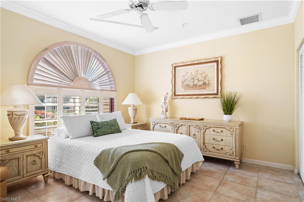 2399 Northwest 24th Street Boca Raton, FL 33434 - Photo 15 of 23 Guest Bedroom featuring ceiling fan, ornamental molding, and light tile patterned floors
