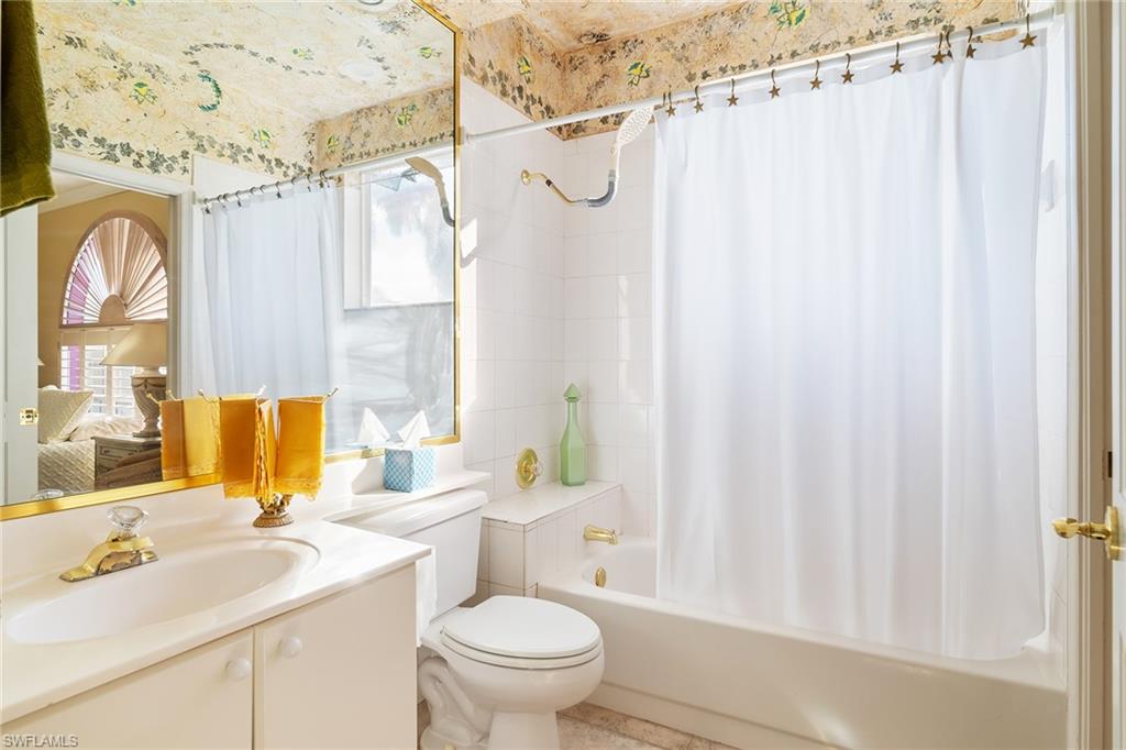 2399 Northwest 24th Street Boca Raton, FL 33434 - Photo 17 of 23 Full bathroom featuring vanity, shower / bath combination with curtain, and toilet