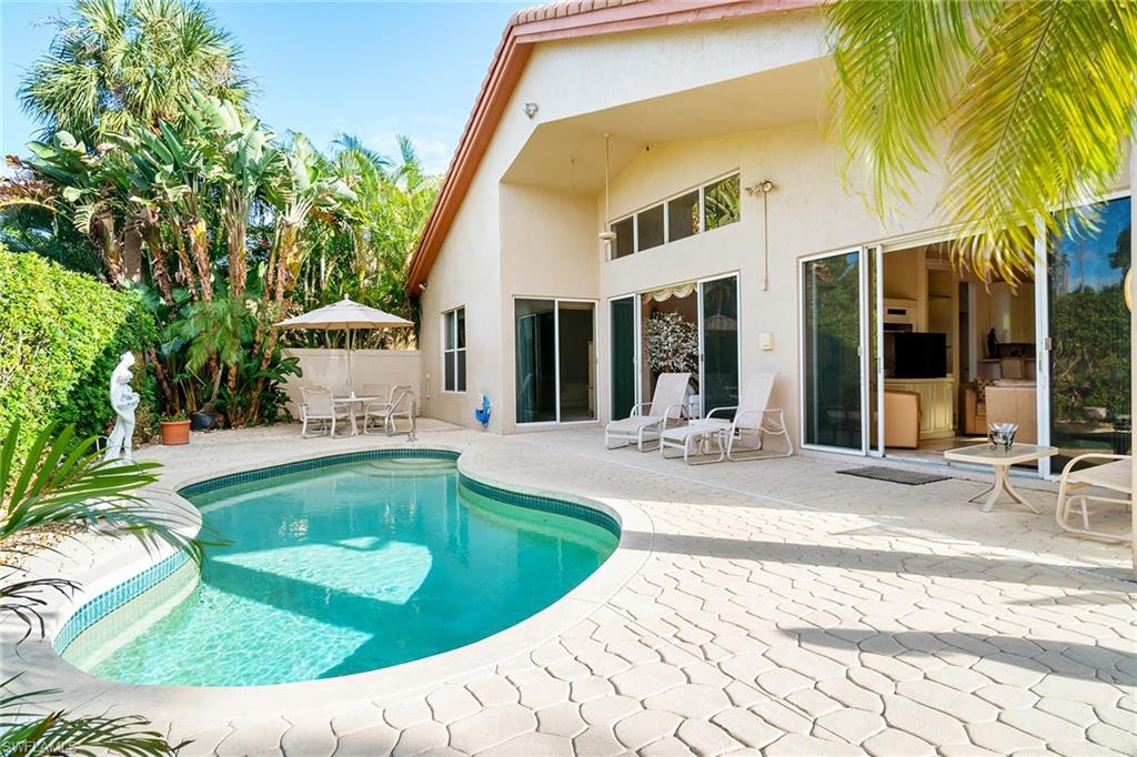 2399 Northwest 24th Street Boca Raton, FL 33434 - Photo 18 of 23 Back of property with a fenced in pool and a patio area