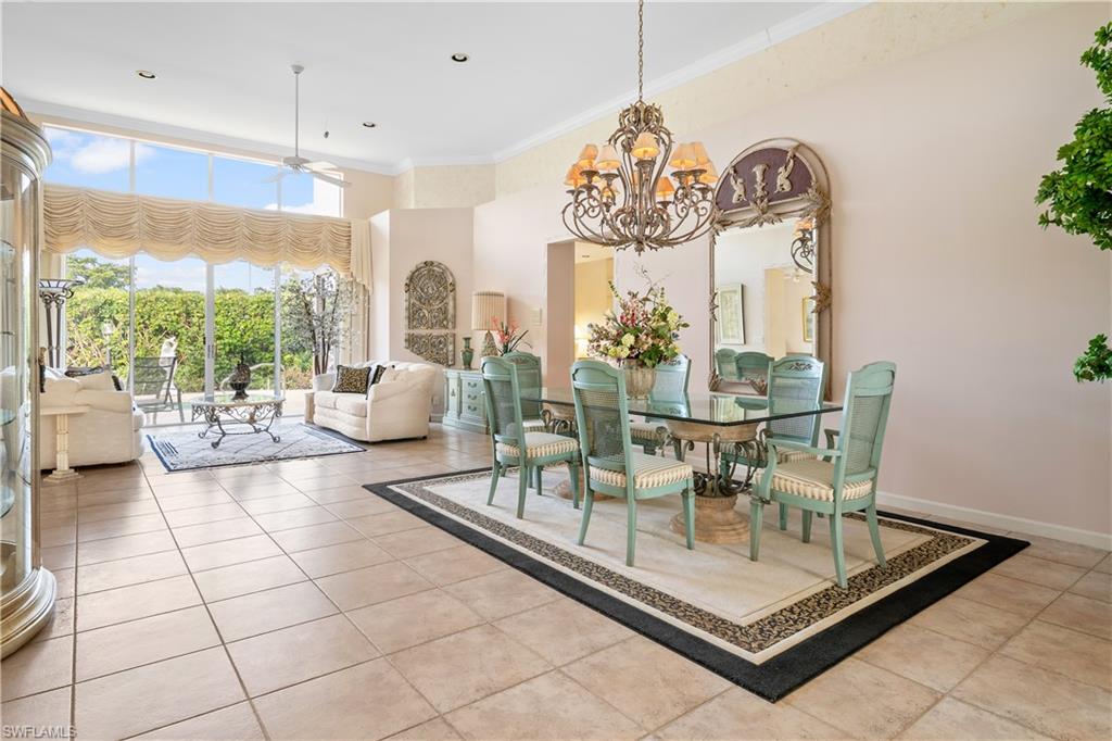 2399 Northwest 24th Street Boca Raton, FL 33434 - Photo 4 of 23 Tiled dining room with ceiling fan with notable chandelier and crown molding