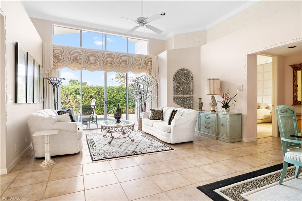 2399 Northwest 24th Street Boca Raton, FL 33434 - Photo 6 of 23 Living room featuring crown molding, a towering ceiling, ceiling fan, and light tile patterned floors