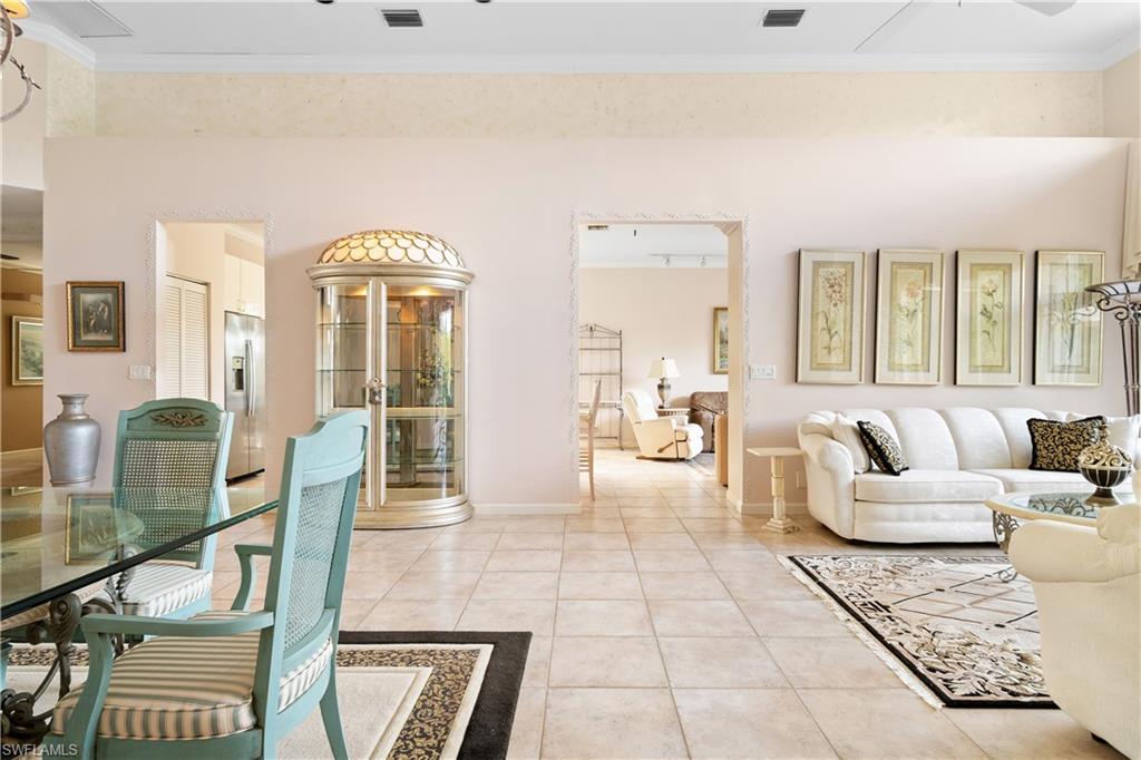 2399 Northwest 24th Street Boca Raton, FL 33434 - Photo 7 of 23 Living room featuring tile patterned flooring and ornamental molding