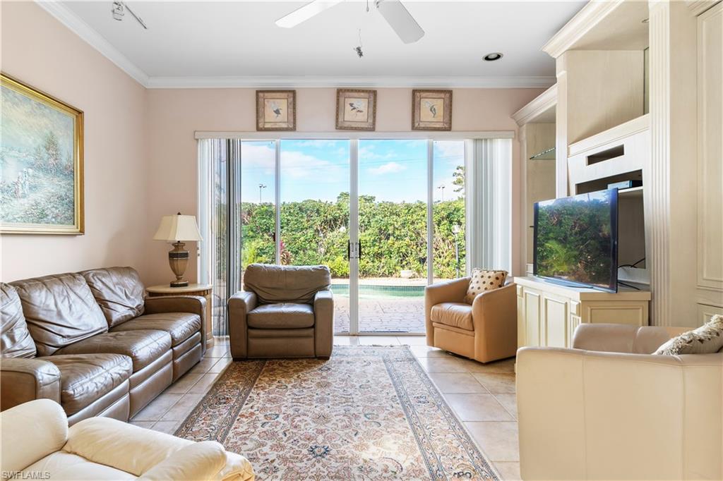 2399 Northwest 24th Street Boca Raton, FL 33434 - Photo 9 of 23 Tiled living room featuring ceiling fan and ornamental molding