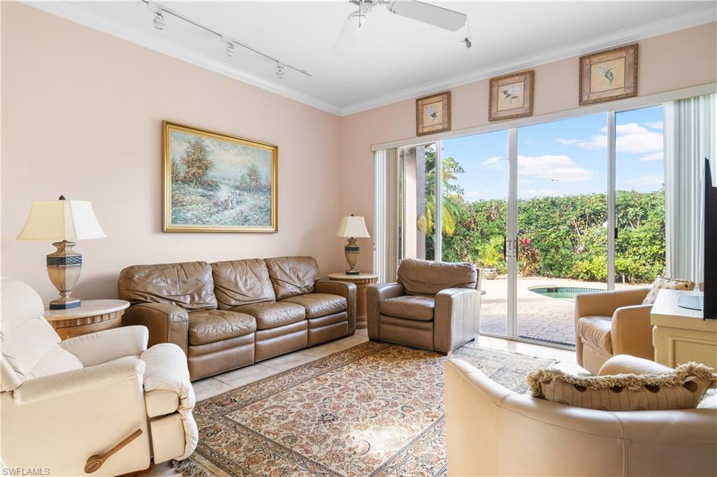 2399 Northwest 24th Street Boca Raton, FL 33434 - Photo 10 of 23 Living room featuring ornamental molding, rail lighting, ceiling fan, and a healthy amount of sunlight