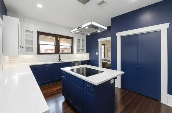 a kitchen with wooden cabinets a sink and a stove