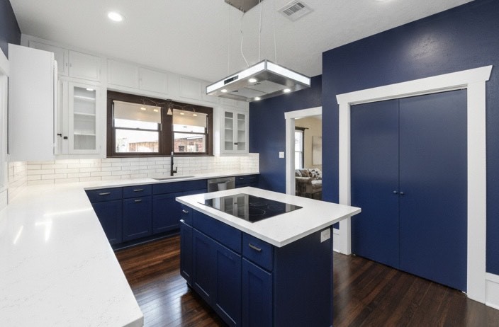 a kitchen with wooden cabinets a sink and a stove