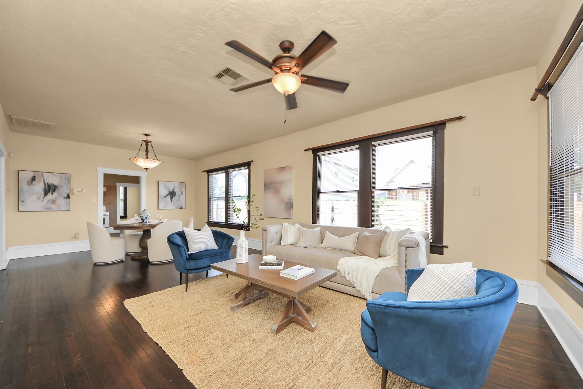 1211 Bingham Street Houston, TX 77007 - Photo 15 of 48 a living room with couches and a dining table with wooden floor