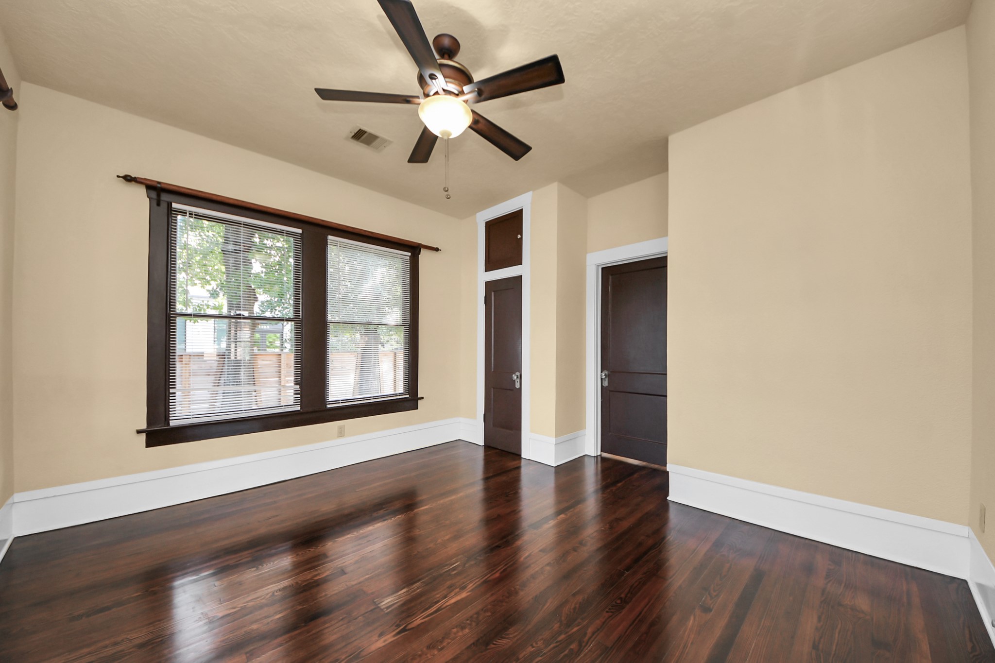 1211 Bingham Street Houston, TX 77007 - Photo 19 of 48 a view of an empty room with wooden floor and a window