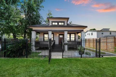 a front view of a house with a garden and yard