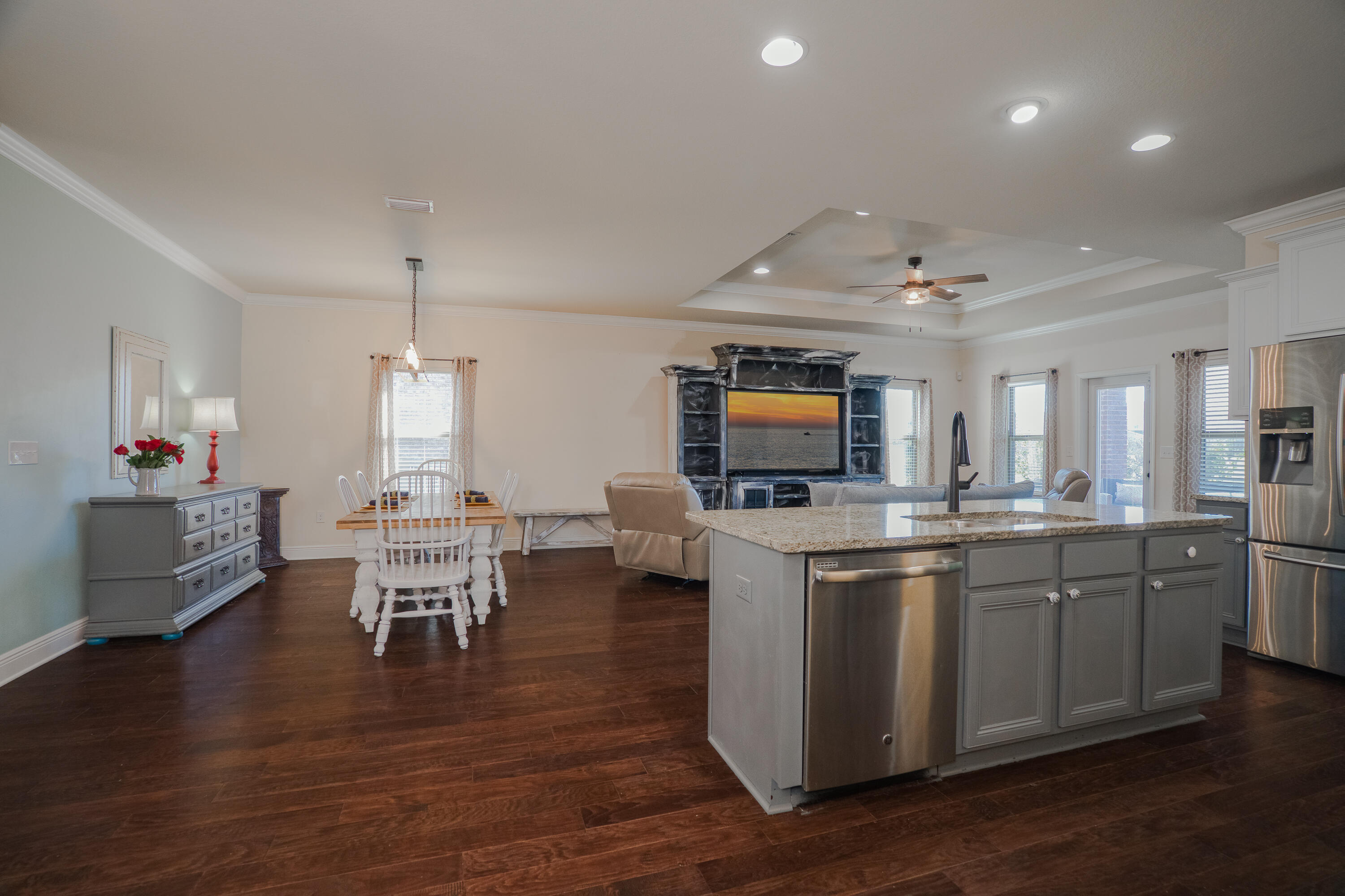 165 Pin Oak Loop Santa Rosa Beach, FL 32459 - Photo 20 of 41 a open kitchen with stainless steel appliances granite countertop a stove top oven a sink dishwasher a dining table and chairs with wooden floor
