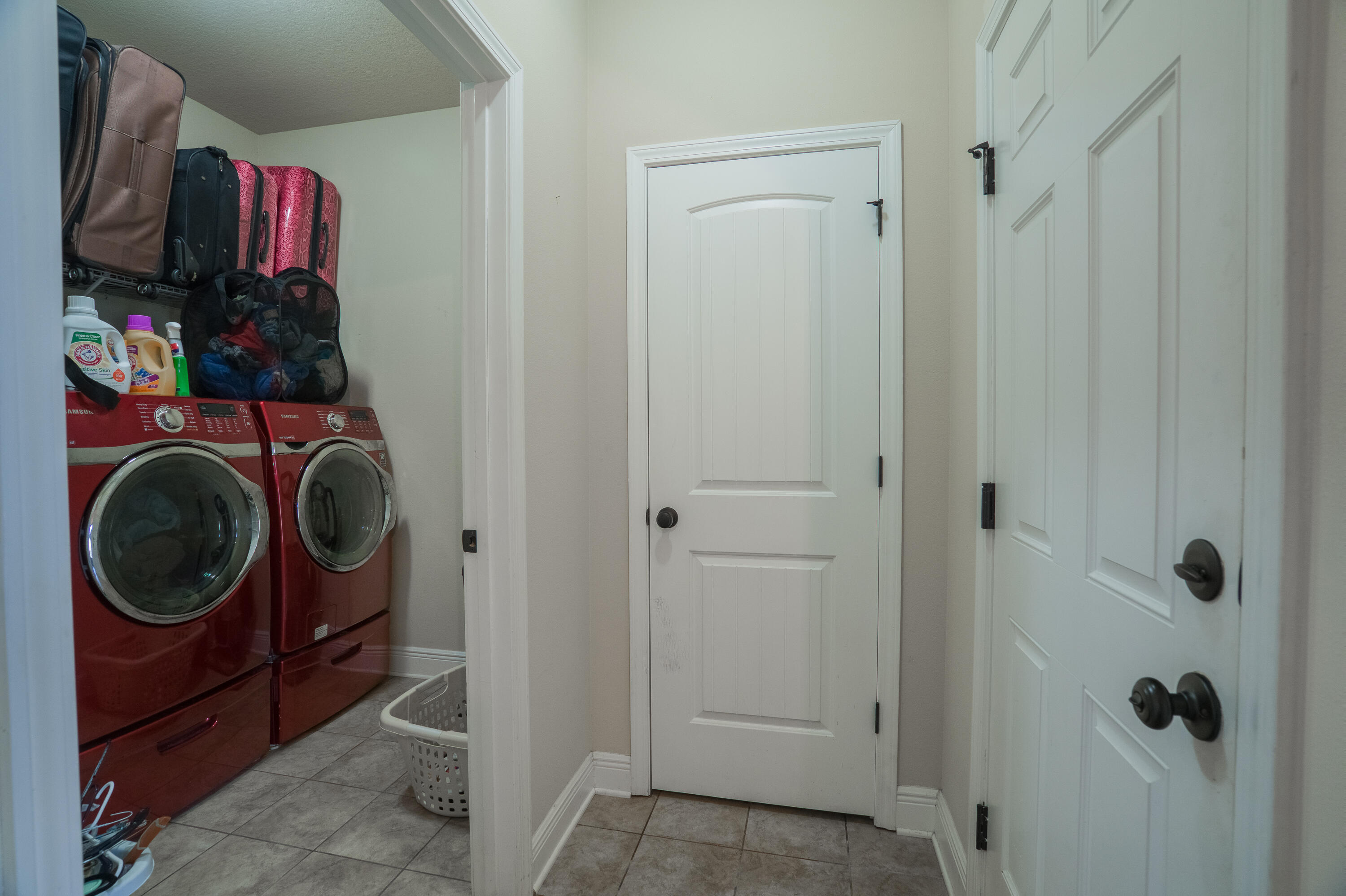 165 Pin Oak Loop Santa Rosa Beach, FL 32459 - Photo 31 of 41 a view of a hallway with washer and dryer