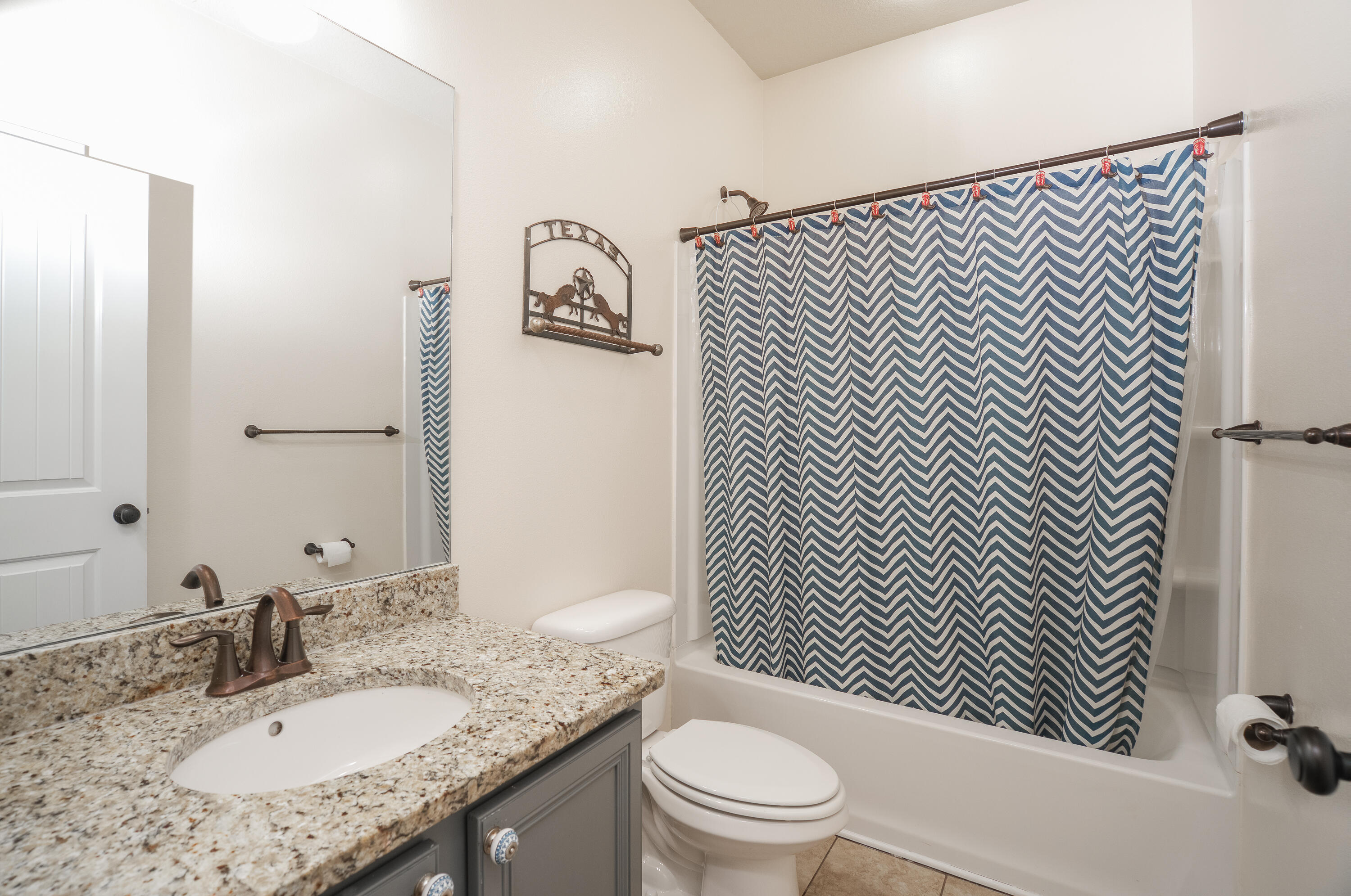 165 Pin Oak Loop Santa Rosa Beach, FL 32459 - Photo 37 of 41 a bathroom with a granite countertop toilet sink and mirror