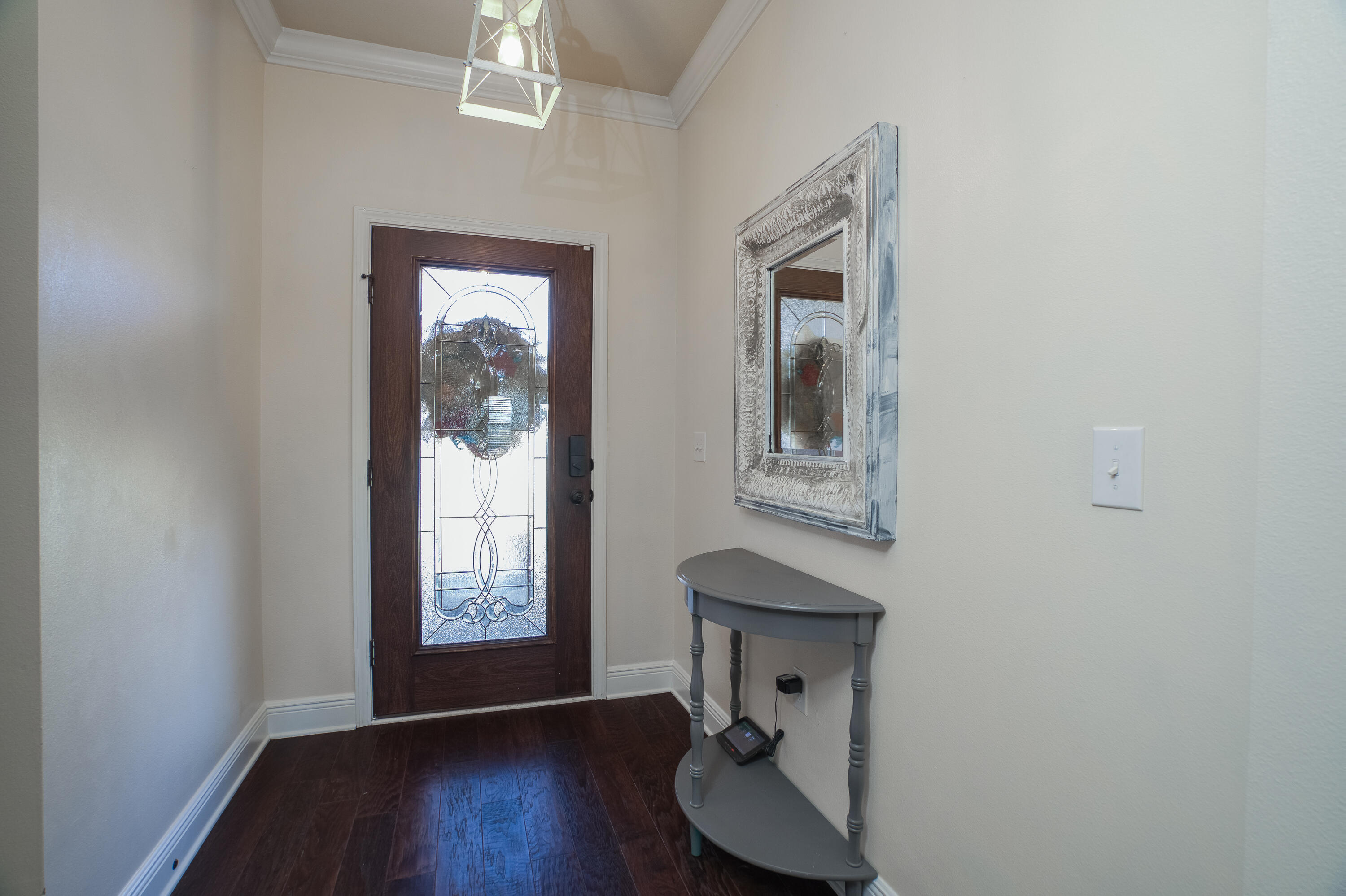 165 Pin Oak Loop Santa Rosa Beach, FL 32459 - Photo 6 of 41 a view of an entryway with wooden floor windows and a chandelier