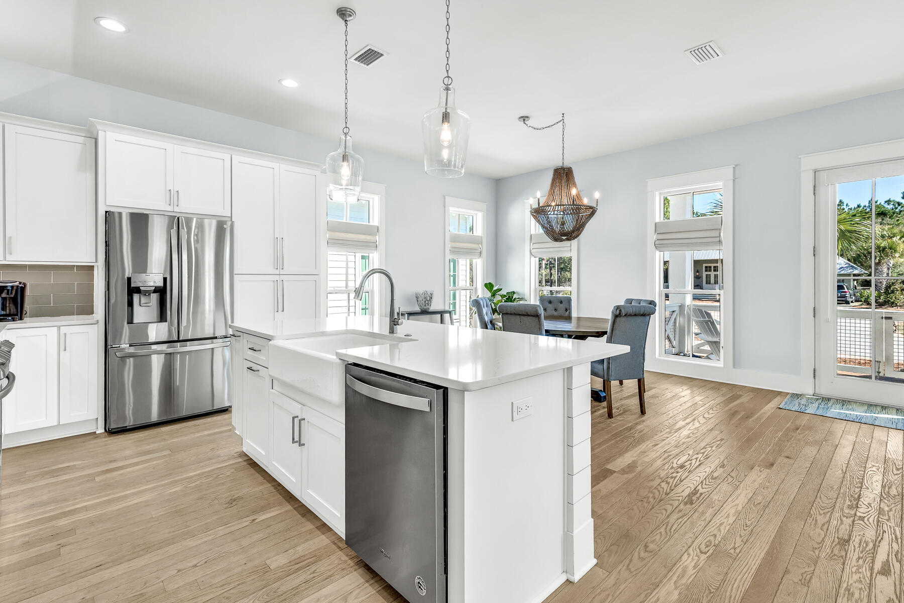 56 Cypress Drive Santa Rosa Beach, FL 32459 - Photo 13 of 61 a kitchen with stainless steel appliances kitchen island granite countertop a sink a stove a refrigerator and island with wooden floor