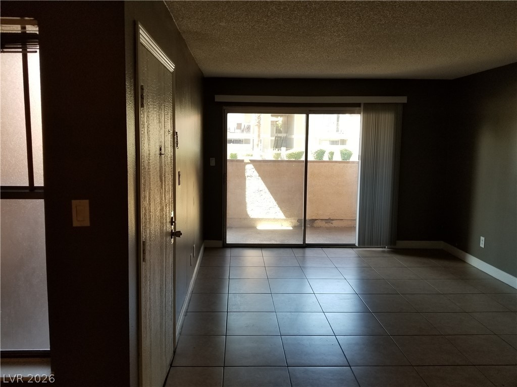 1515 East Reno Avenue, Unit A103 Las Vegas, NV 89119 - Photo 6 of 16 This interior space features durable tile flooring, providing both style and practicality.