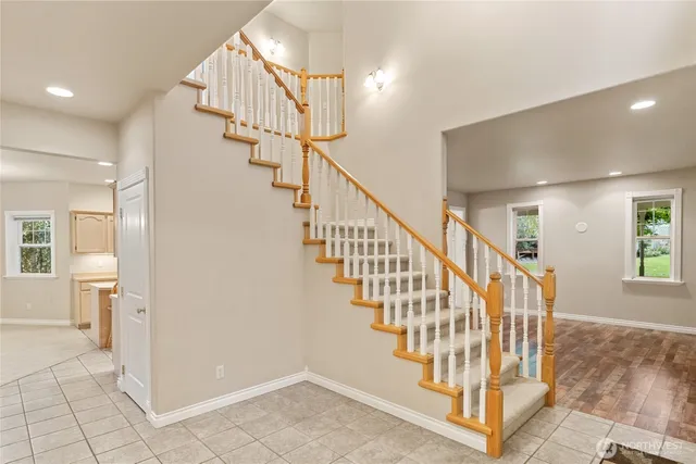 a view of entryway and hall with wooden floor
