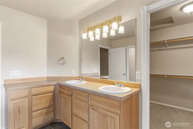 a bathroom with a sink vanity and a mirror