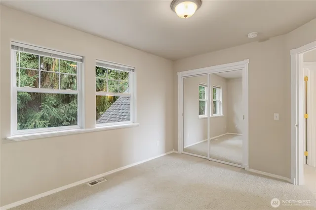 an empty room with windows and closet