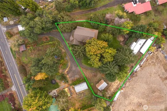 an aerial view of a house with a yard and lake view