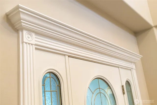 a close view of a utility room with dryer and entryway