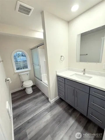 a spacious bathroom with a double vanity sink and a mirror