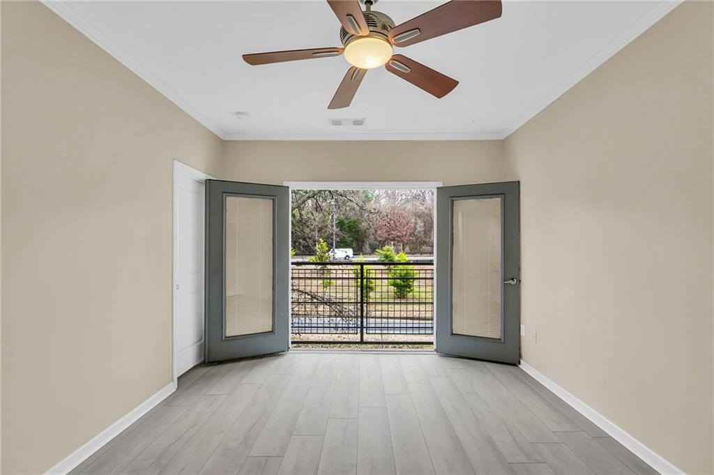 821 Ralph McGill Boulevard Northeast, Unit 3325 Atlanta, GA 30306 - Photo 19 of 54 an empty room with windows and ceiling fan