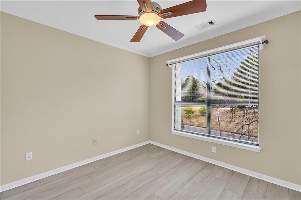 821 Ralph McGill Boulevard Northeast, Unit 3325 Atlanta, GA 30306 - Photo 21 of 54 an empty room with chandelier fan and windows