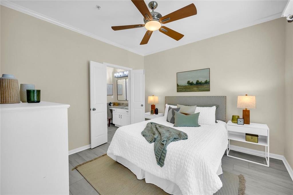 821 Ralph McGill Boulevard Northeast, Unit 3325 Atlanta, GA 30306 - Photo 22 of 54 a bedroom with a bed and a chandelier