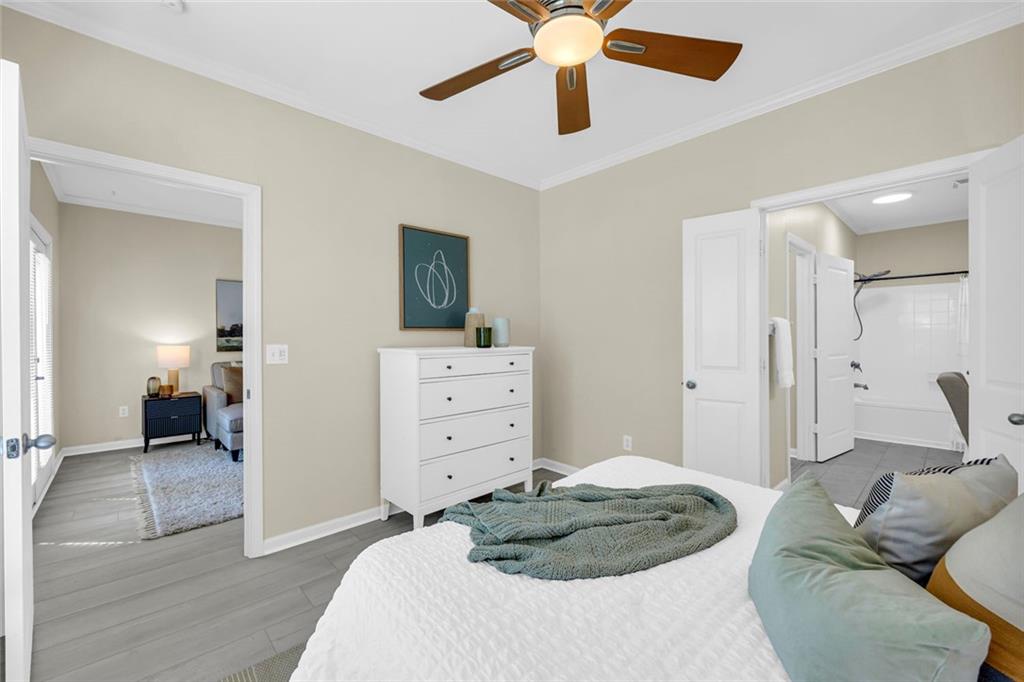 821 Ralph McGill Boulevard Northeast, Unit 3325 Atlanta, GA 30306 - Photo 24 of 54 a bedroom with a bed and a chandelier