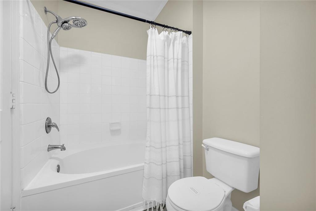 821 Ralph McGill Boulevard Northeast, Unit 3325 Atlanta, GA 30306 - Photo 29 of 54 a white toilet sitting next to a bath tub and a shower