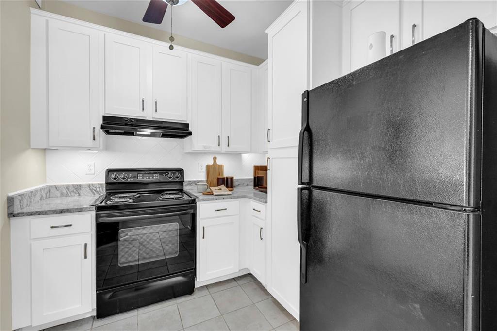 821 Ralph McGill Boulevard Northeast, Unit 3325 Atlanta, GA 30306 - Photo 4 of 54 a kitchen with stainless steel appliances a refrigerator sink and cabinets