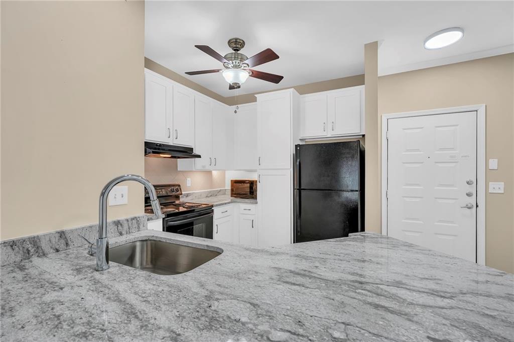 821 Ralph McGill Boulevard Northeast, Unit 3325 Atlanta, GA 30306 - Photo 10 of 54 a kitchen with stainless steel appliances granite countertop a sink a refrigerator and a stove