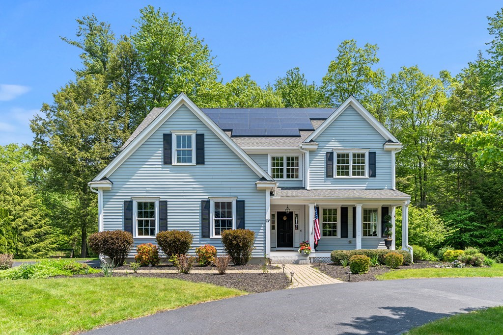 a front view of a house with patio and garden