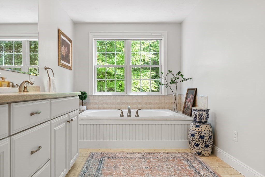 19 Village Road Pepperell, MA 01463 - Photo 20 of 41 a bathroom with a sink and a bathtub