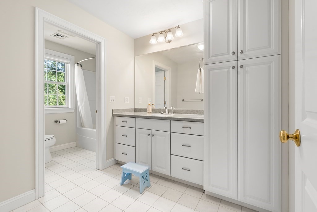 19 Village Road Pepperell, MA 01463 - Photo 23 of 41 a spacious bathroom with a double vanity sink a mirror and a bathtub