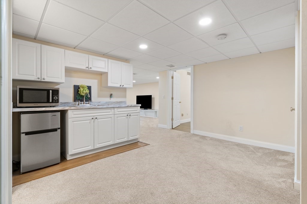 19 Village Road Pepperell, MA 01463 - Photo 27 of 41 a kitchen with white cabinets and stainless steel appliances