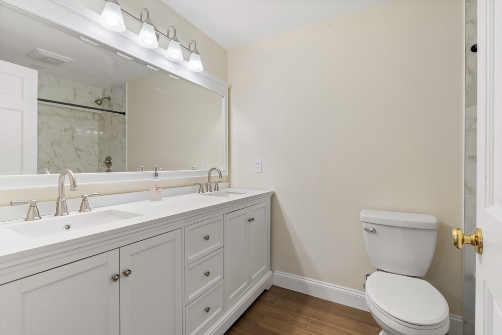 19 Village Road Pepperell, MA 01463 - Photo 28 of 41 a bathroom with a toilet a sink and mirror