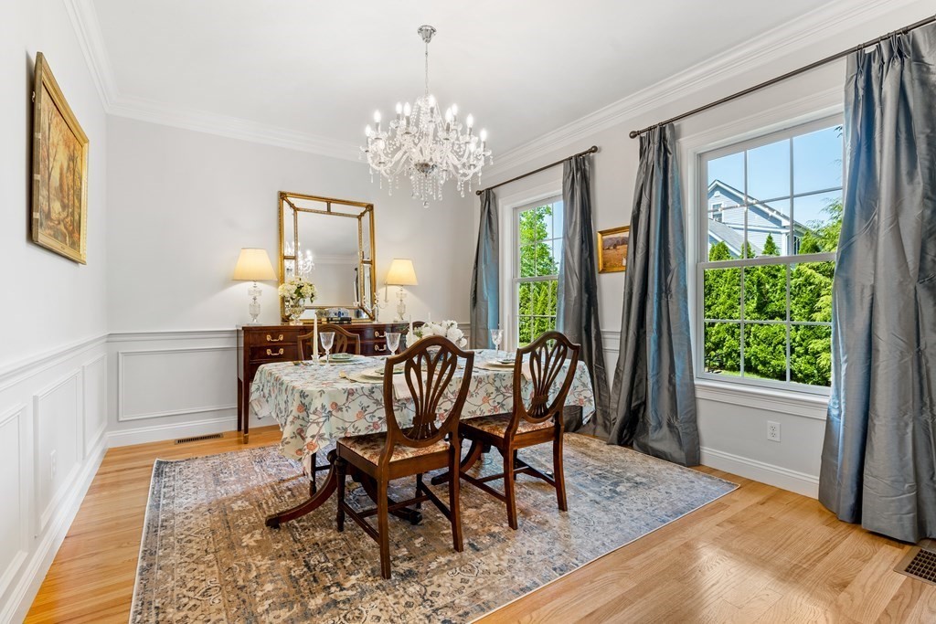 19 Village Road Pepperell, MA 01463 - Photo 7 of 41 a view of a dining room with furniture a chandelier and wooden floor