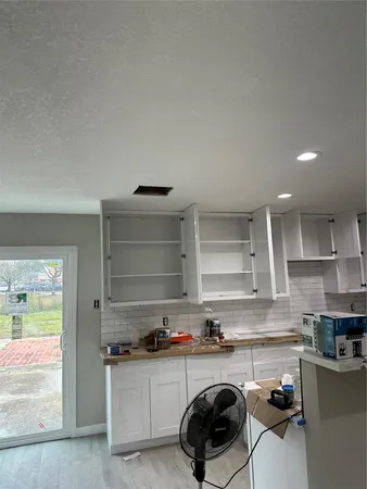 a kitchen with a sink a stove and cabinets