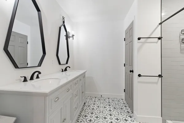 a bathroom with a sink and mirror with toilet