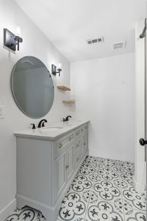 a bathroom with a sink and mirror with toilet