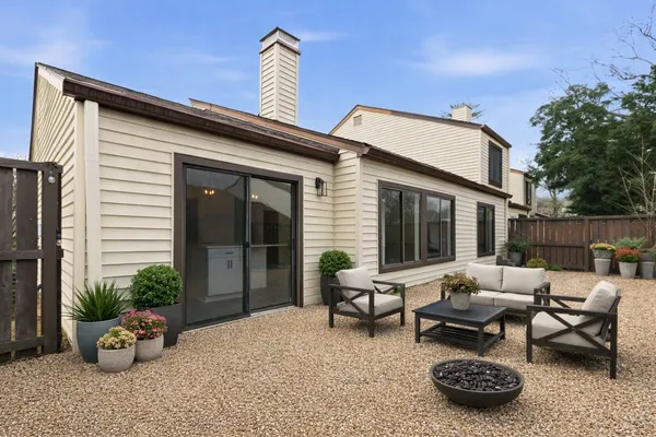 a building outdoor space with patio furniture and potted plants
