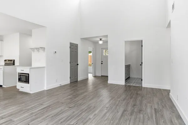 a view of a hallway with wooden floor
