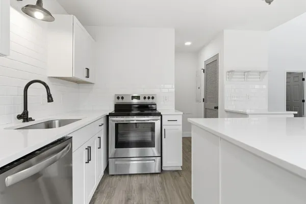 a kitchen with a sink cabinets and stainless steel appliances