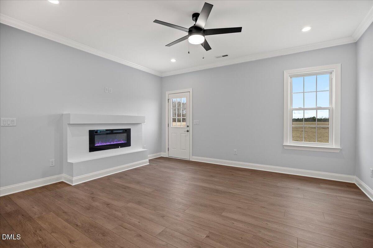 1300 Nick Coley Road Whitakers, NC 27891 - Photo 23 of 47 an empty room with windows and fireplace