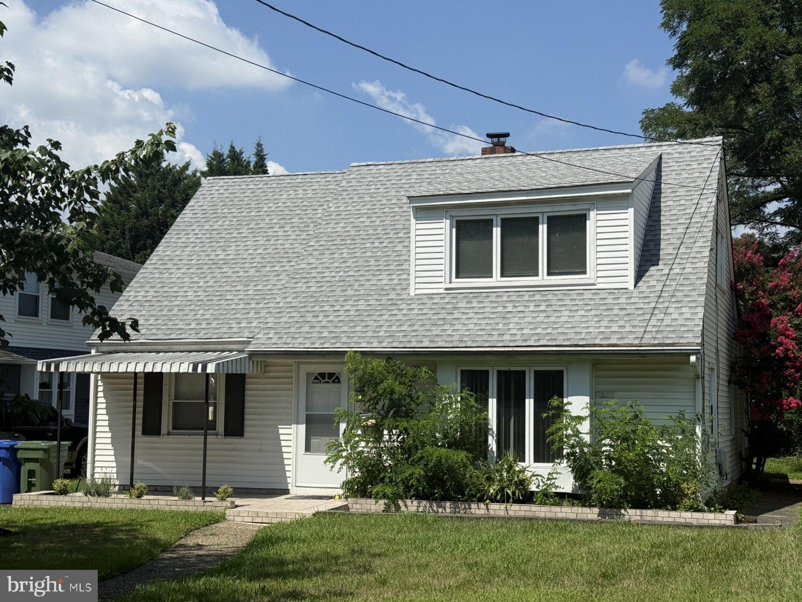 a front view of a house with a yard and outdoor seating